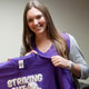 Ali Brems shows Center Director Dr. Sanjay Asthana the t-shirt for her second Alzheimer's fundraiser, a May 24 softball game.