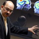 Center director Dr. Sanjay Asthana shows how brain scans identify areas of the brain affected by disease.