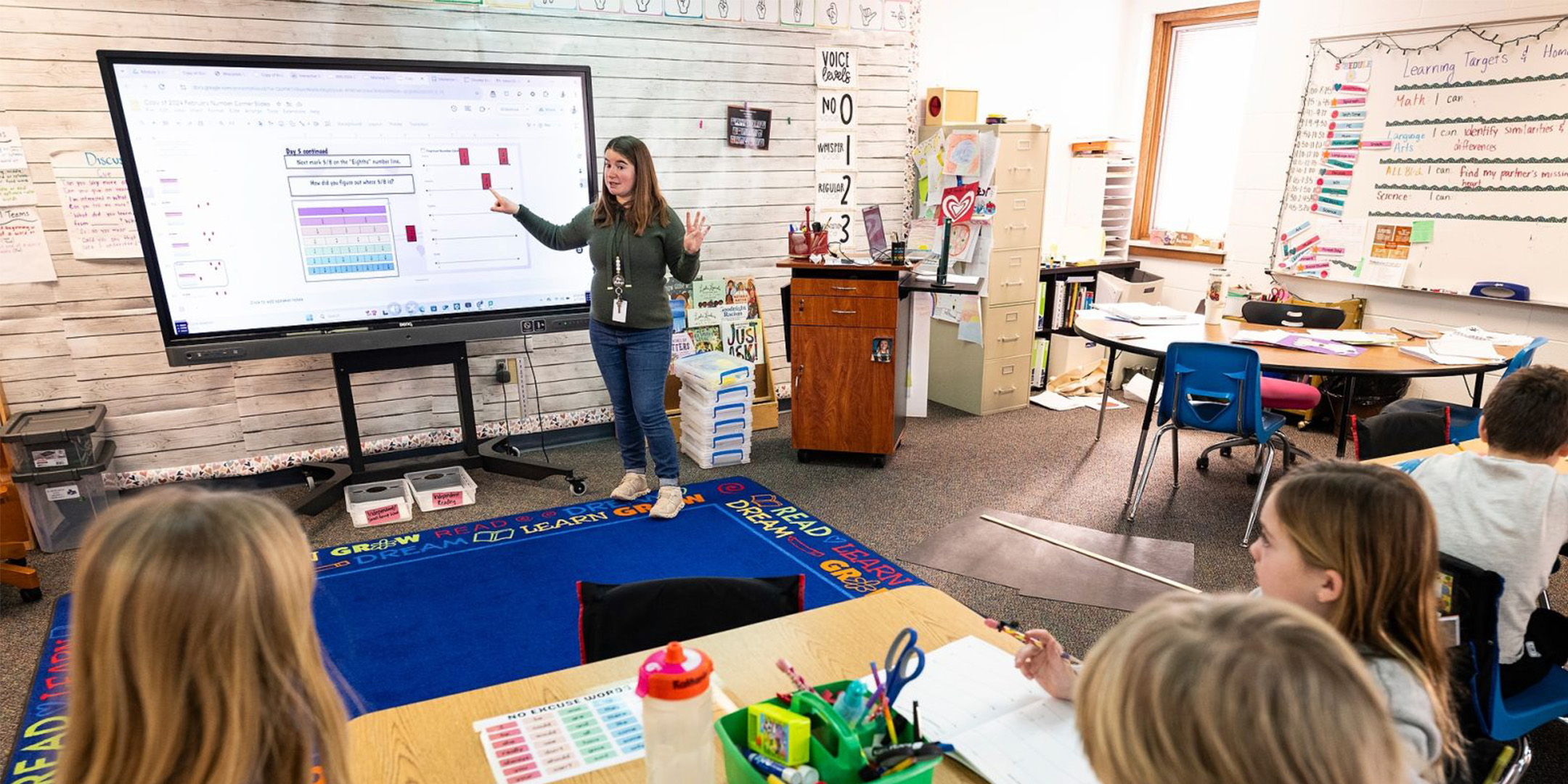 Teacher shown conducting a lesson for young students