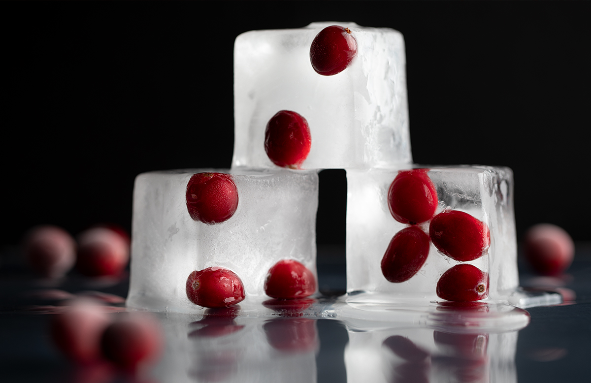 Cranberries embedded in ice cubes.