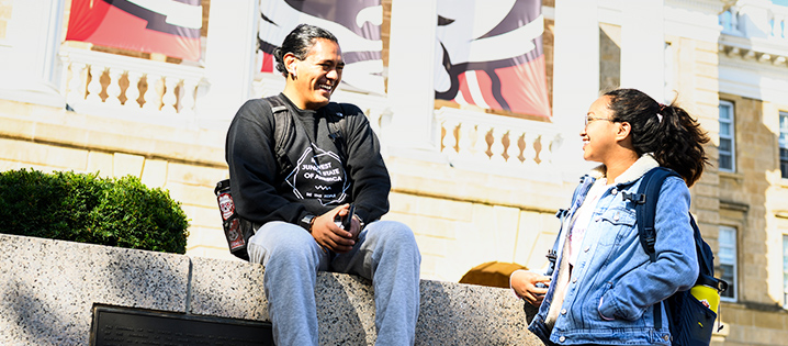 Two students talking outside of Bascom Hall