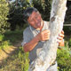 UW Student Alejandra Huerta discusses a fruit tree disease with a farmer.