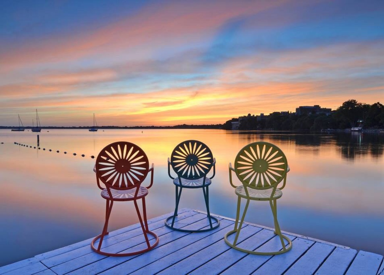 Three Terrace chairs overlooking a sunset on Lake Mendota