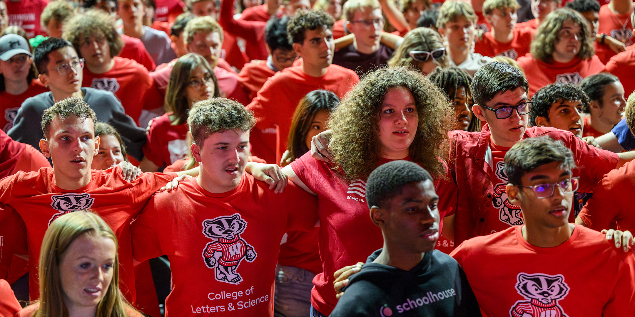 Students wearing red shirts huddled up