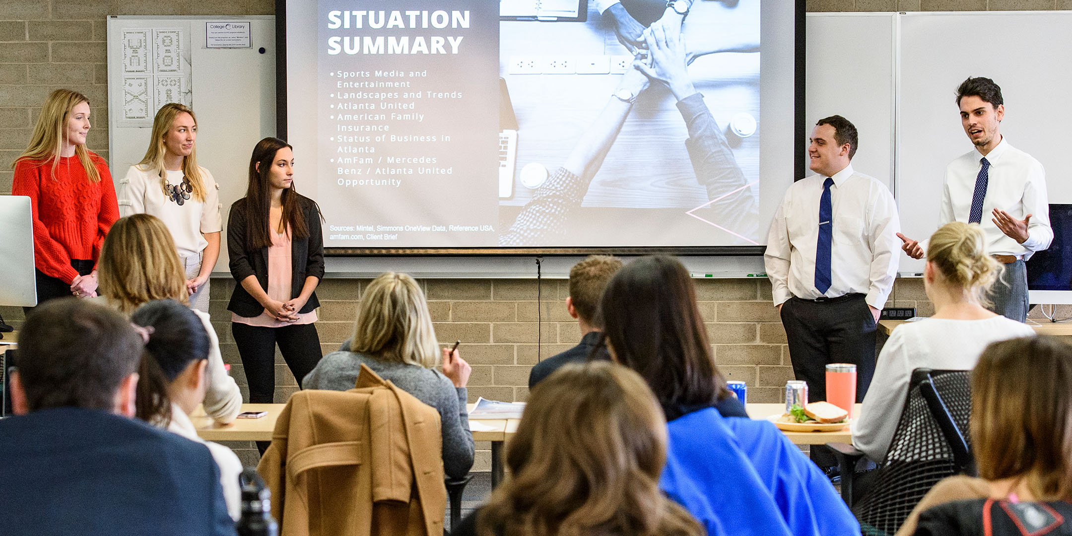 Students presenting a project in front of their classmates