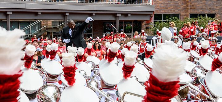 UW Marching Band director, Corey Pompey, leading the band.