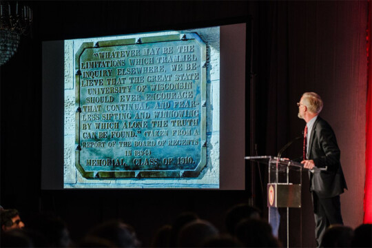 A presenter examining an image on a projected screen