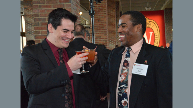 Two friends cheering their drinks together