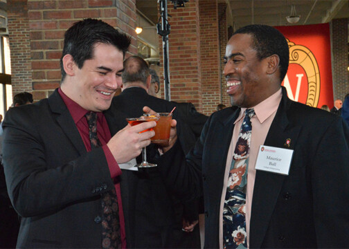 Two friends cheering their drinks together