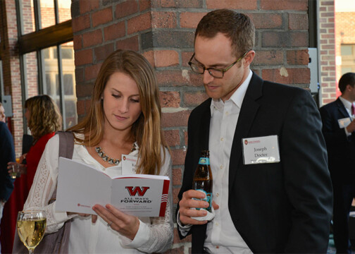 Two individuals looking at a booklet