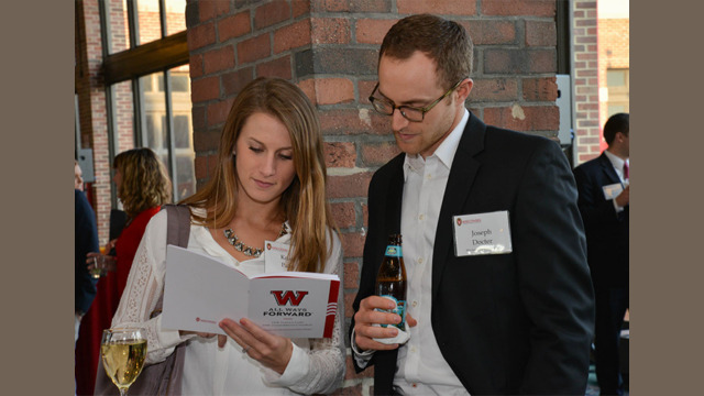 Two individuals looking at a booklet