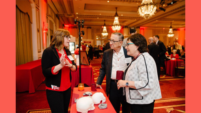Attendees hearing about artifacts at a booth