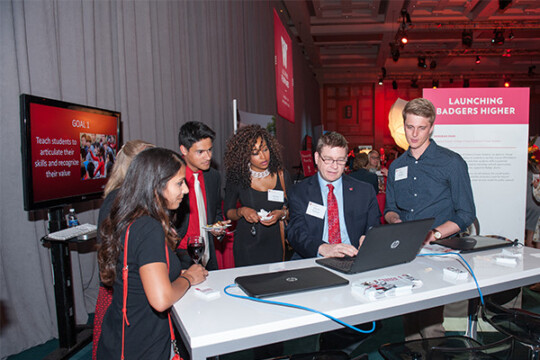 Attendees examining information on a laptop