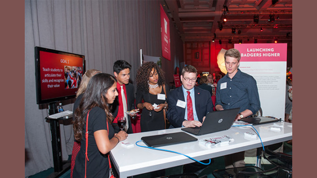 Attendees examining information on a laptop
