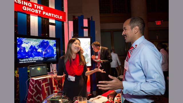 A pair of attendees examining a booth