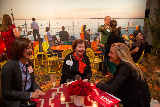 Attendees sitting at tables with a backdrop to recreate the Union Terrace