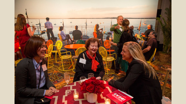 Attendees sitting at tables with a backdrop to recreate the Union Terrace