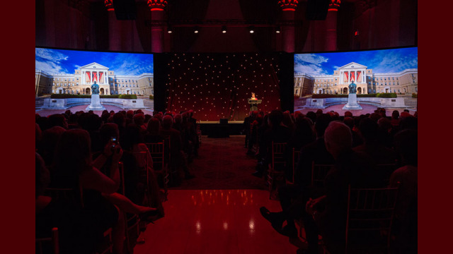 A presenter speaking on stage