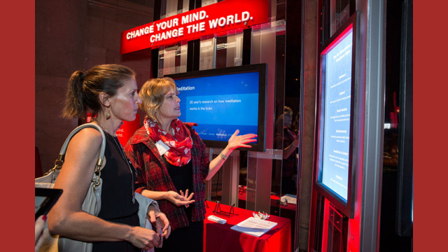 A pair of attendees examining a booth