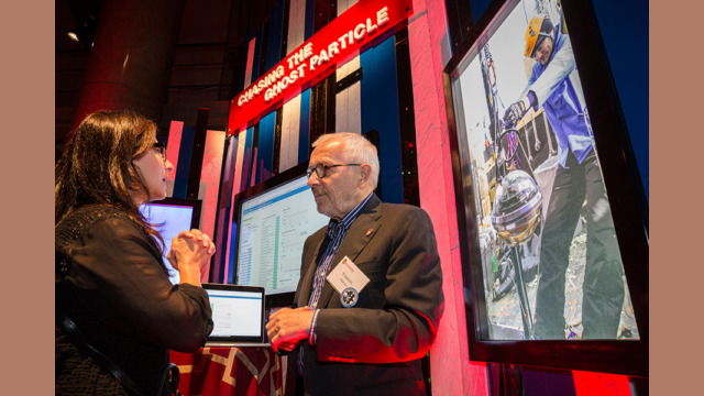 A pair of attendees examining a booth