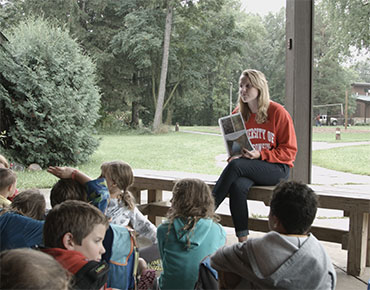 UW–Madison student talking with children