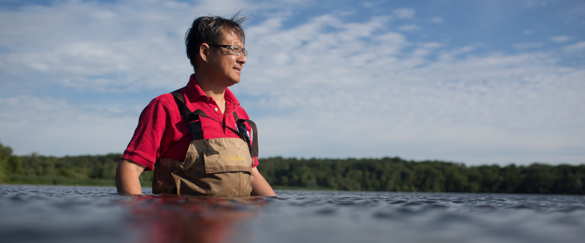 College of Engineering professor Chin Wu wading in the water