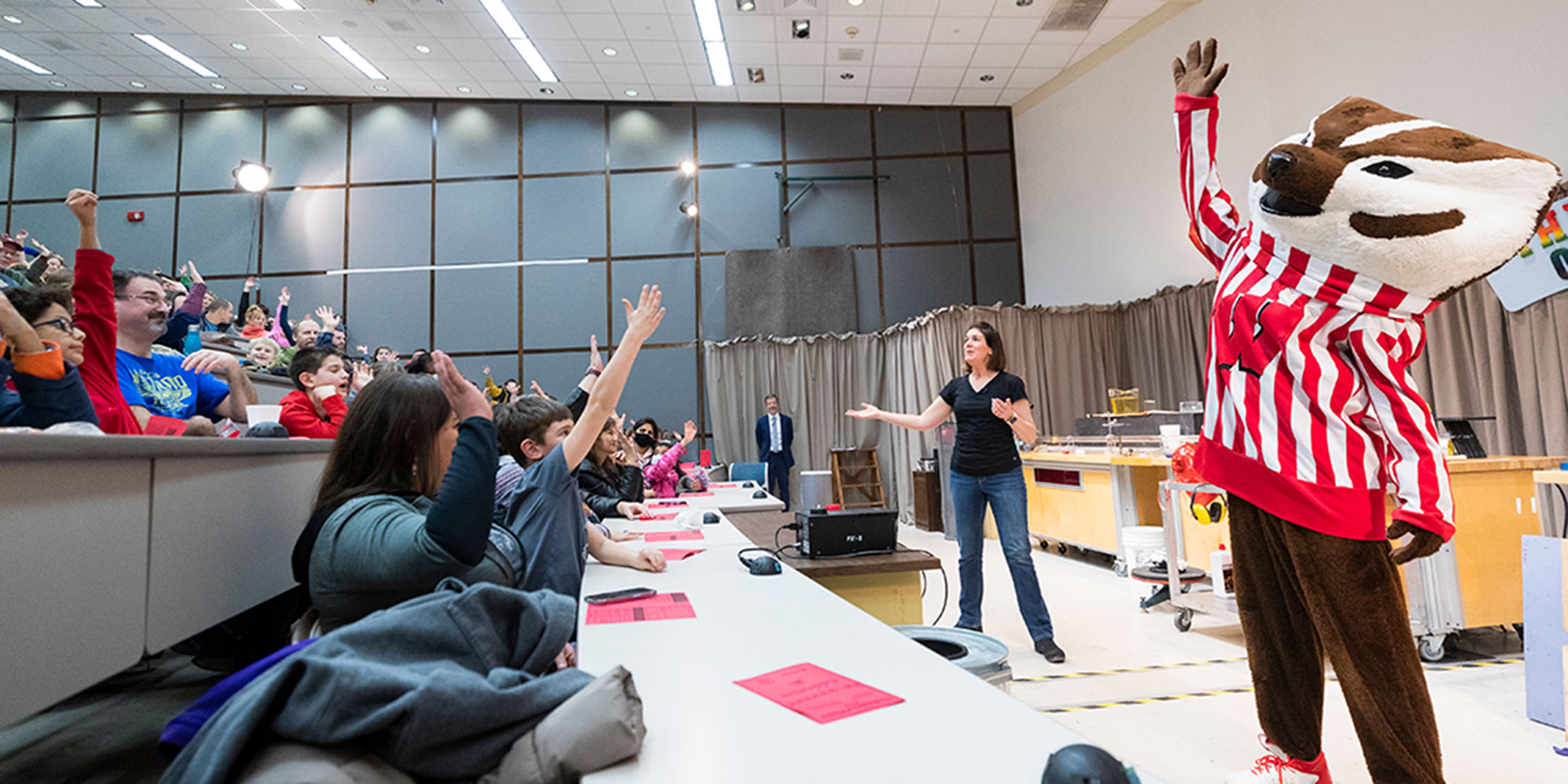 Students in a lecture with professor and Bucky Badger