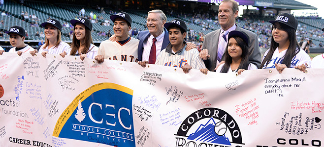 Major League Baseball Commissioner Allan H. “Bud” Selig ‘56 (center) is joined by Colorado Rockies owner/chairman and CEO Dick Monfort and local students